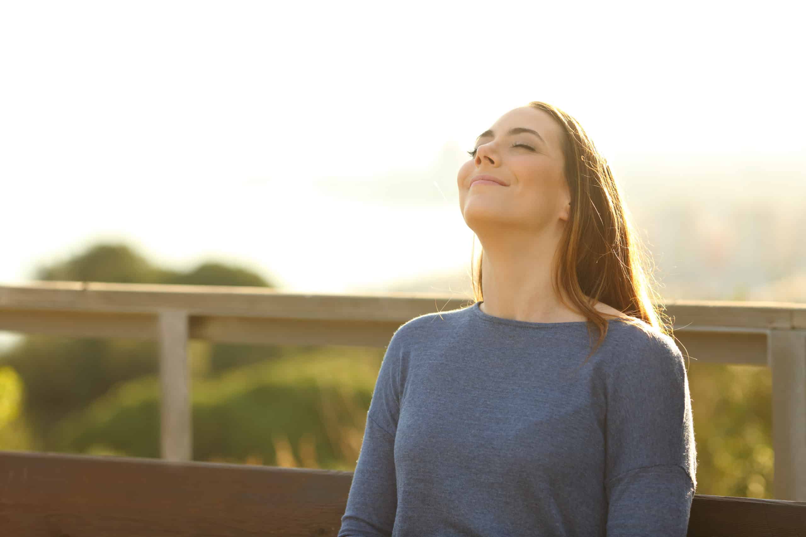 Woman sitting on a bench breathing fresh air in a park